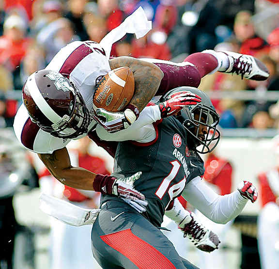 Mississippi State Bulldogs running back LaDarius Perkins (27) dives into the end zone against Arkansas Razorbacks safety Eric Bennett (14) during the second quarter at War Memorial Stadium.